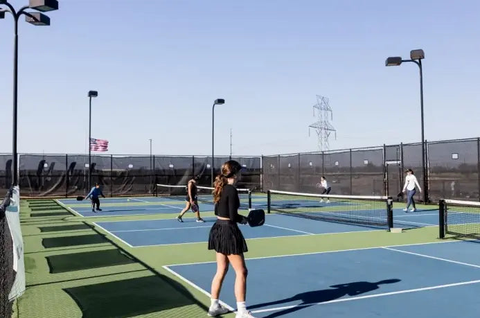 Pickleball beginners practicing drills and footwork during training session on court